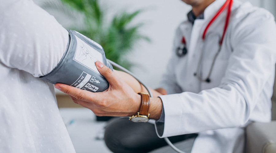 young male psysician with patient measuring blood pressure 1